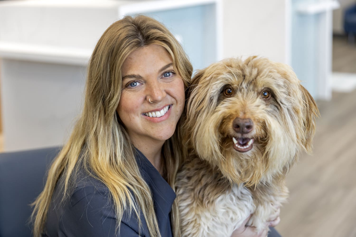 Livewell employee hugging pet and posing for picture